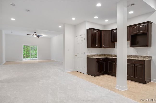 Kitchenette in basement with tile floor | Image 43