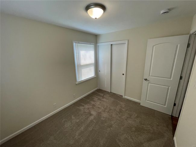 Unfurnished bedroom with baseboards, carpet flooring, and a closet | Image 27