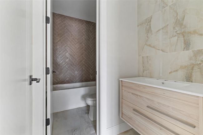 Full bath featuring a bath, toilet, and vanity | Image 33