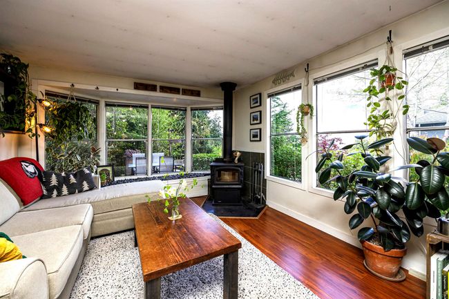 Living Room featuring a wood stove | Image 11
