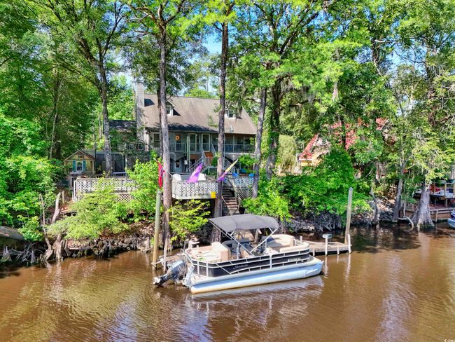 Dock area featuring a water view, stairs, and view of scattered trees | Image 4