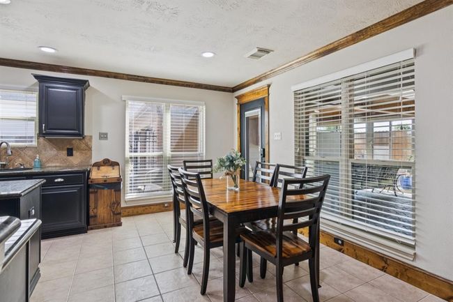Breakfast room with view of the enclosed patio/sunroom. | Image 14