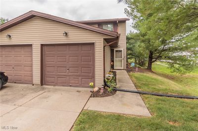 View of front of home featuring a garage and a front lawn | Image 1