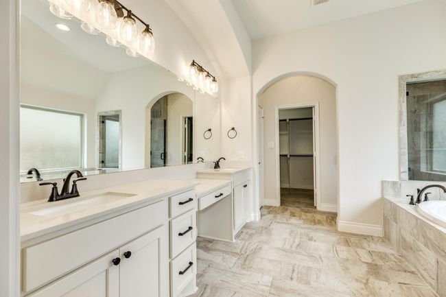 Oversized primary bathroom with double vanities, a make-up area, and a large walk-in closet. | Image 32