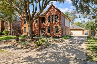 Nestled on a serene, tree-lined avenue, this inviting residence offers tranquility and charm. | Image 2