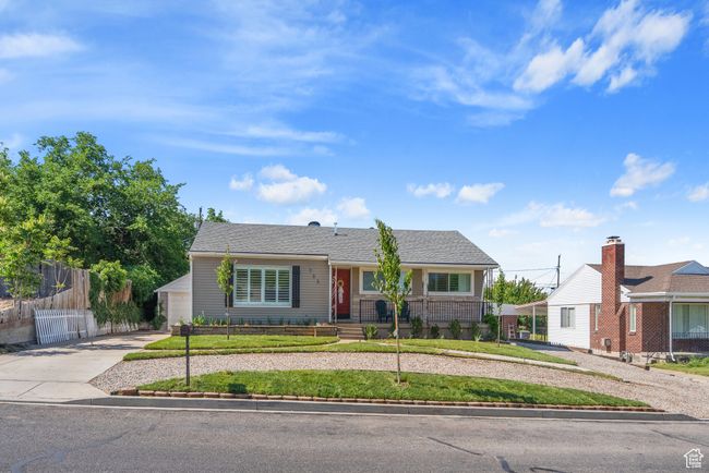 View of front of house with concrete driveway, a fenced front yard, and a garage | Image 37