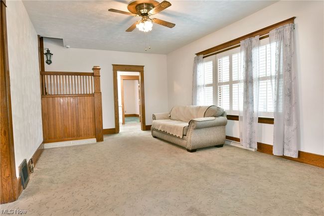 Living area with ceiling fan and light colored carpet | Image 15