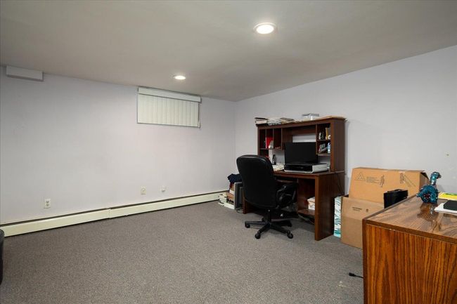 Carpeted home office with a baseboard heating unit and recessed lighting | Image 27