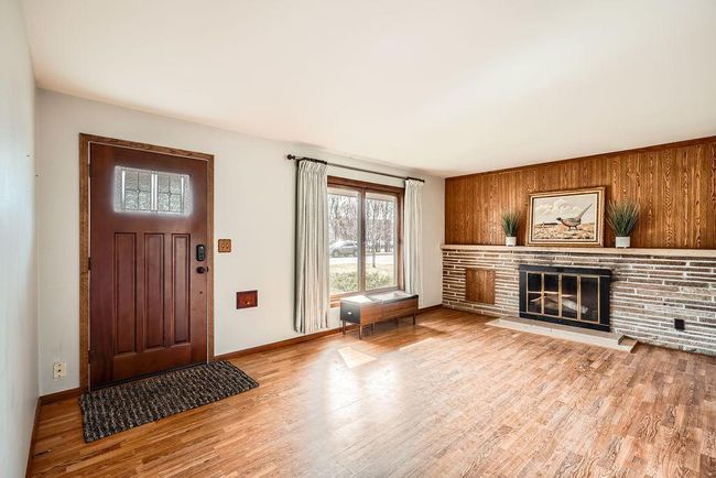 Spacious, light and bring living room with gorgeous brick fireplace. | Image 5