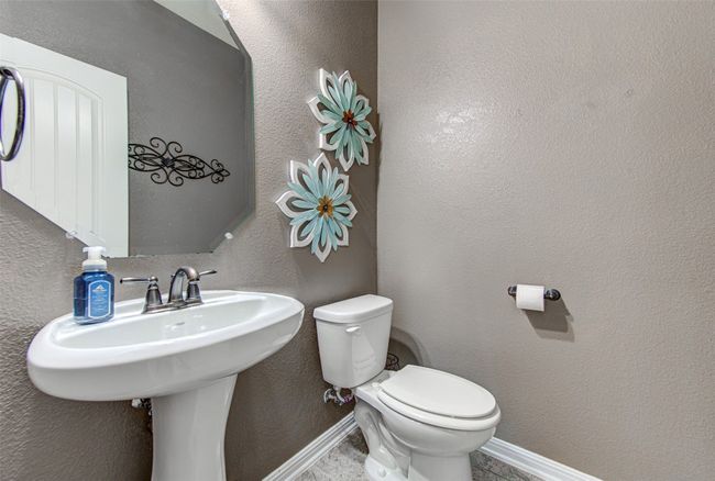 Convenient Half Bath, Perfectly Situated for Visitors, Offers Comfort and Functionality in a Charming Setting | Image 11