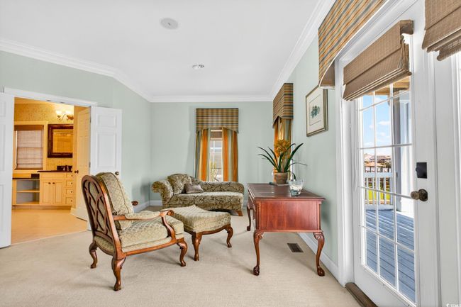 Living area featuring crown molding and light colored carpet | Image 25