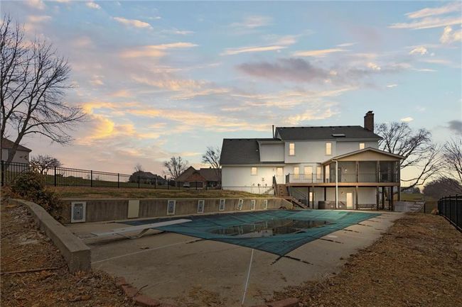 Pool at dusk with a sunroom and a patio | Image 41