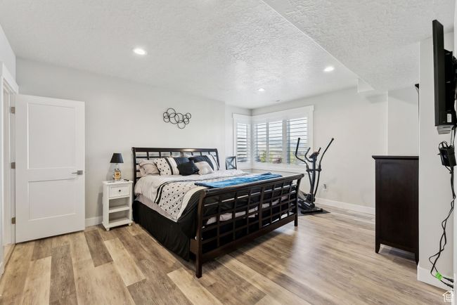 Bedroom featuring baseboards, recessed lighting, and a textured ceiling | Image 23