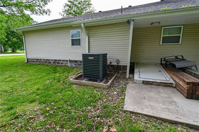 Rear view of house featuring central air condition unit and a lawn | Image 40