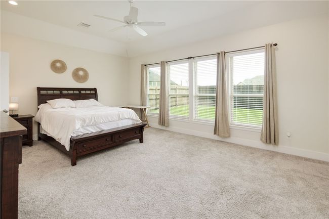 Bedroom featuring carpet floors, baseboards, and a ceiling fan | Image 11