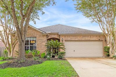 This beautiful 1-story home in River's Edge is ready for new owners to love. Inside find fresh neutral finishes including tile flooring in the living and dining areas with plush carpet in the bedrooms, neutral paint, crown molding, arched doorways, chic lighting and fans, and a wonderful covered patio and fenced yard for outdoor play. | Image 1