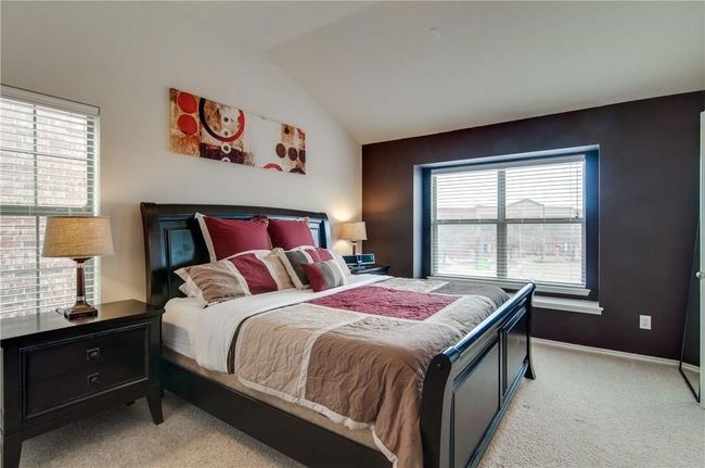 Bedroom with lofted ceiling and light colored carpet | Image 23