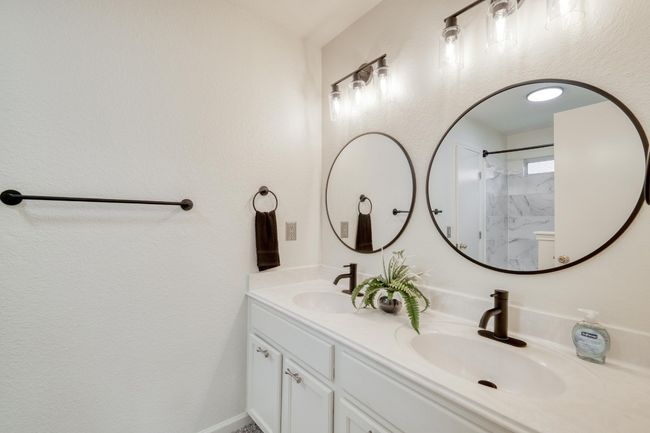 Bathroom with double vanity and a shower | Image 17