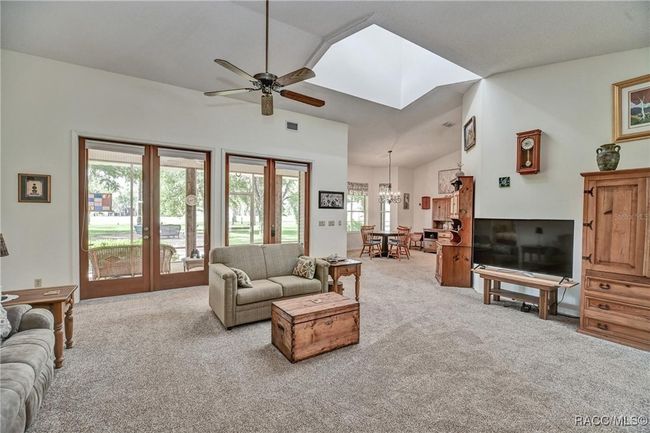 Living room, high ceiling, opens to two porches, lots of natural light | Image 9