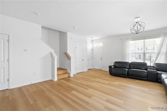 Living area featuring stairs, baseboards, and light wood-style floors | Image 9