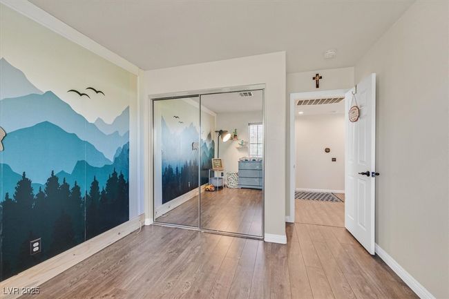 Unfurnished bedroom with a closet, visible vents, baseboards, and wood finished floors | Image 25