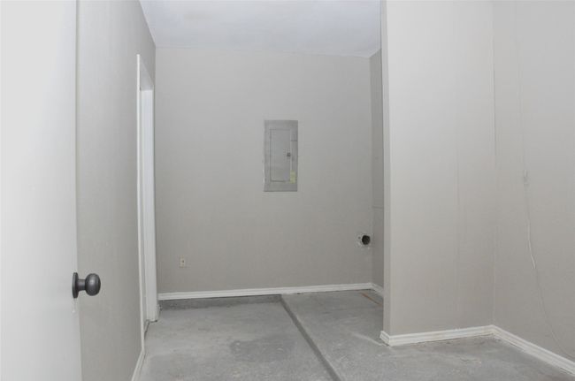 Clothes washing area featuring electric panel and baseboards | Image 26
