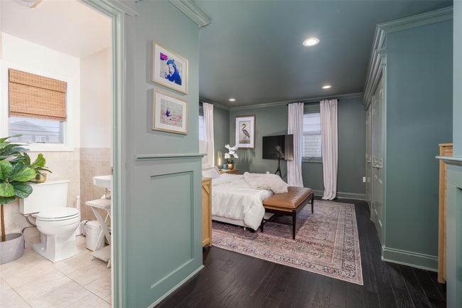 Bedroom with ensuite bath, crown molding, multiple windows, and wainscoting | Image 24