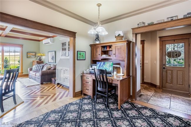 Office space with baseboards, a wall mounted AC, and crown molding | Image 19