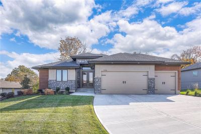 Prairie-style home featuring a garage and a front lawn | Image 3