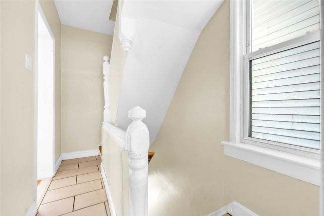 Bathroom with tile patterned floors and baseboards | Image 7