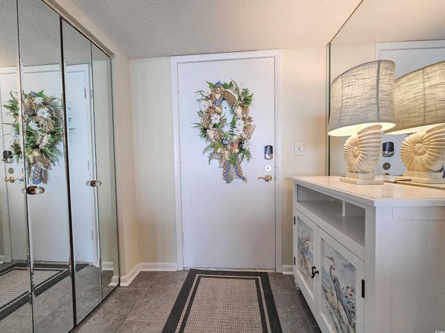 Foyer entrance featuring baseboards and a textured ceiling | Image 12