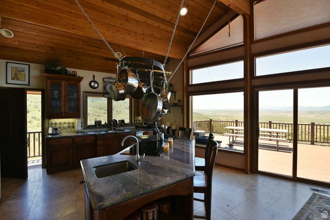 Dining room featuring beam ceiling, tile patterned floors, wooden ceiling, and high vaulted ceiling | Image 72