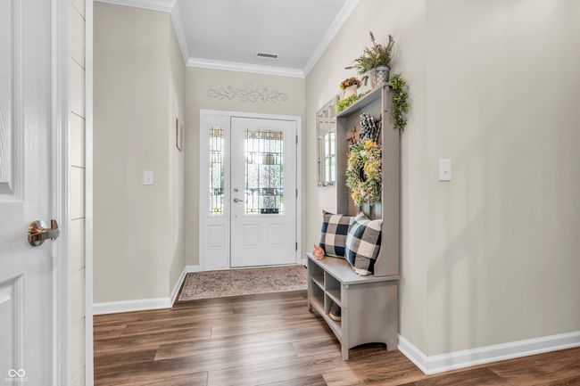 entrance foyer with crown molding and vinyl plank flooring - welcome home! | Image 8