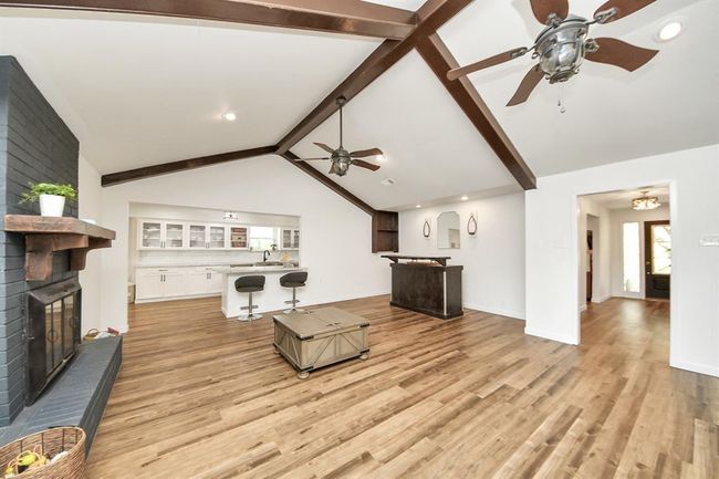 Extra-large living area with a cozy brick fireplace, bar nook, and plenty of space to relax or entertain with ease. | Image 5