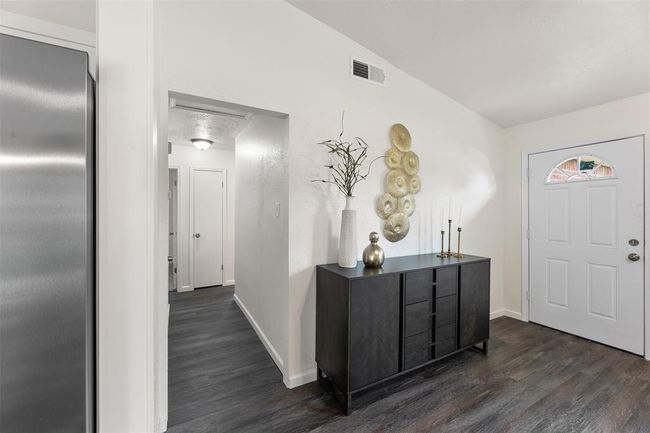 Updated hallway with new flooring and fresh paint. | Image 12