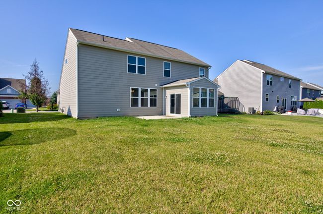 back of house with a lawn and a patio | Image 50
