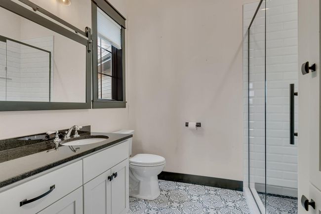 Steps from the guest main floor bedroom, a bath gives guests the feel of a private suite of their own. | Image 60