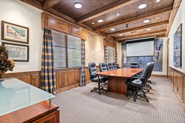 Carpeted office space with beamed ceiling, recessed lighting, a wainscoted wall, and wooden walls | Image 11