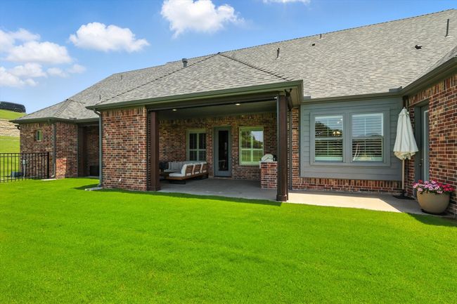 Back of property with brick siding, a patio area, and a shingled roof | Image 36