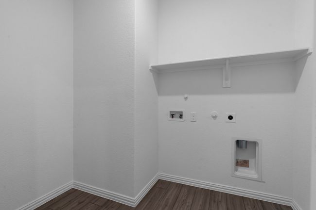 Laundry area featuring gas dryer hookup, dark wood finished floors, hookup for a washing machine, and hookup for an electric dryer | Image 11