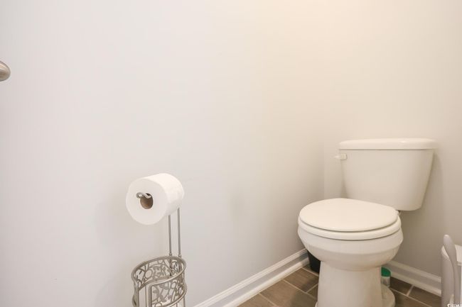 Bathroom with baseboards, toilet, and wood finished floors | Image 14
