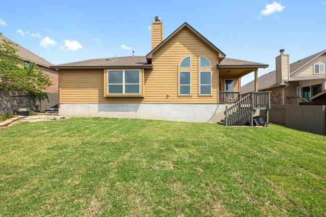 Rear view of house featuring a lawn, a chimney, and fence | Image 29