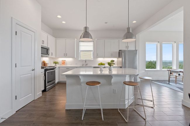 Enjoy scenic views while whipping up your favorite meals with this gorgeous chef-inspired island kitchen. | Image 4