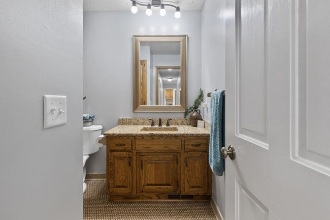 Upper-level full bath with ceramic tile flooring and a spacious storage closet—designed for both function and comfort. | Image 23