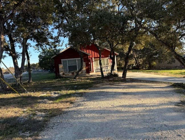 View of front of home with covered porch. | Image 33