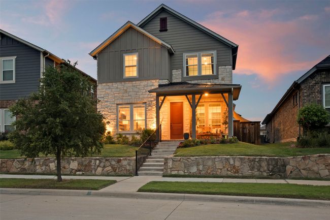 Traditional home featuring board and batten siding, stone siding, and a yard | Image 36