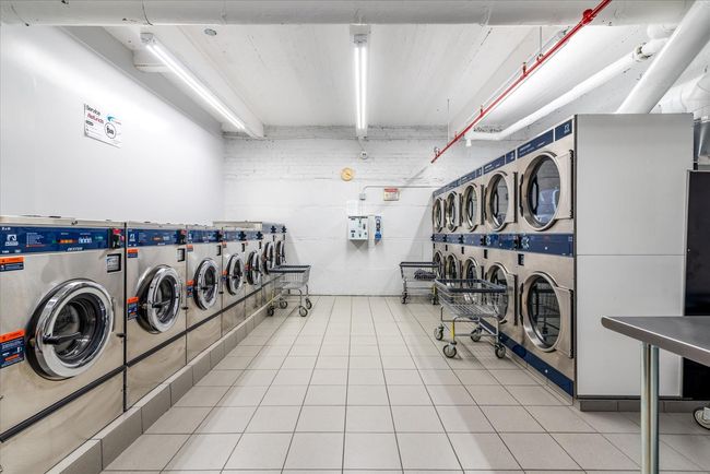 Shared laundry room with washing machine and clothes dryer and tile patterned floors | Image 10