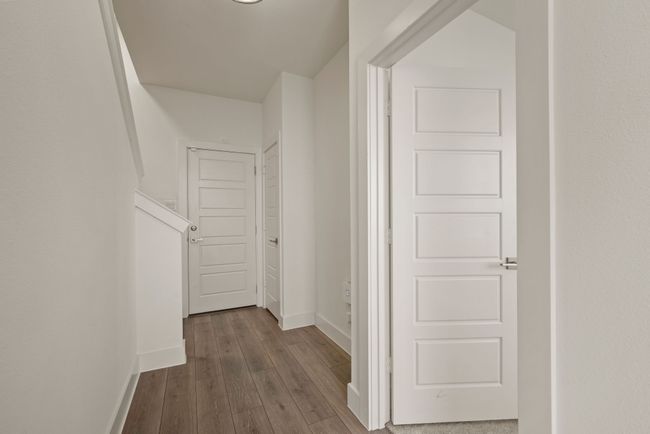 Hall featuring baseboards and dark wood-style flooring | Image 10