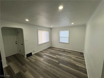 Empty room with a textured ceiling and dark hardwood / wood-style flooring | Image 2