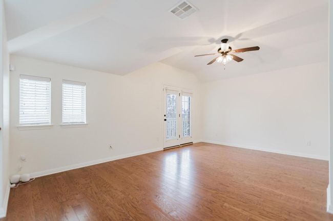 Upstairs Living Room, baseboards, lofted ceiling, wood finished floors, and a ceiling fan | Image 19